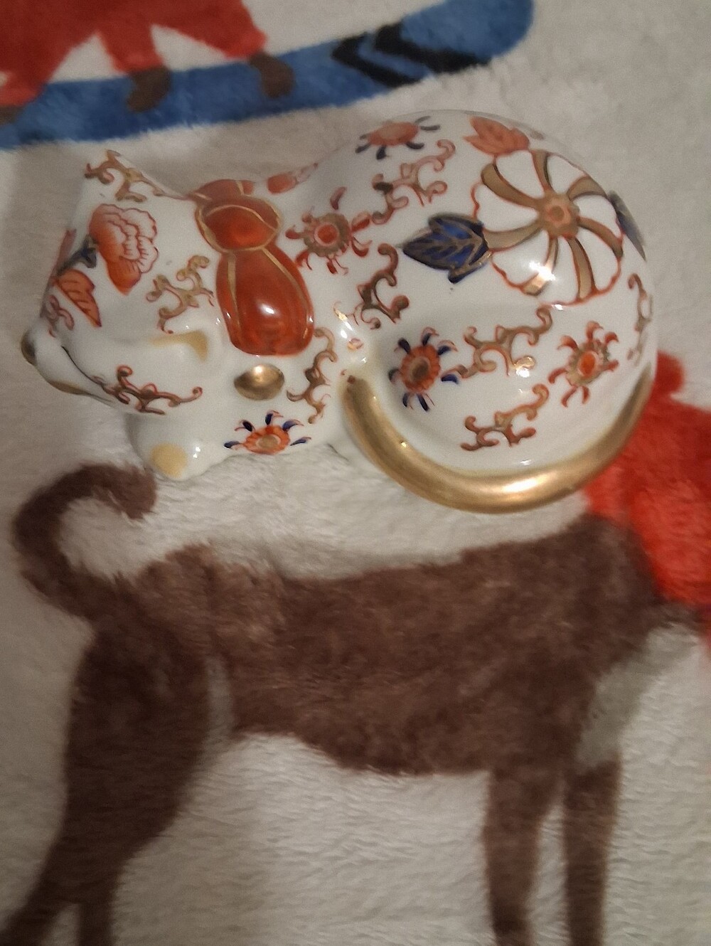 Decorative White Porcelain Cat Figurine with Orange and Gold Accents